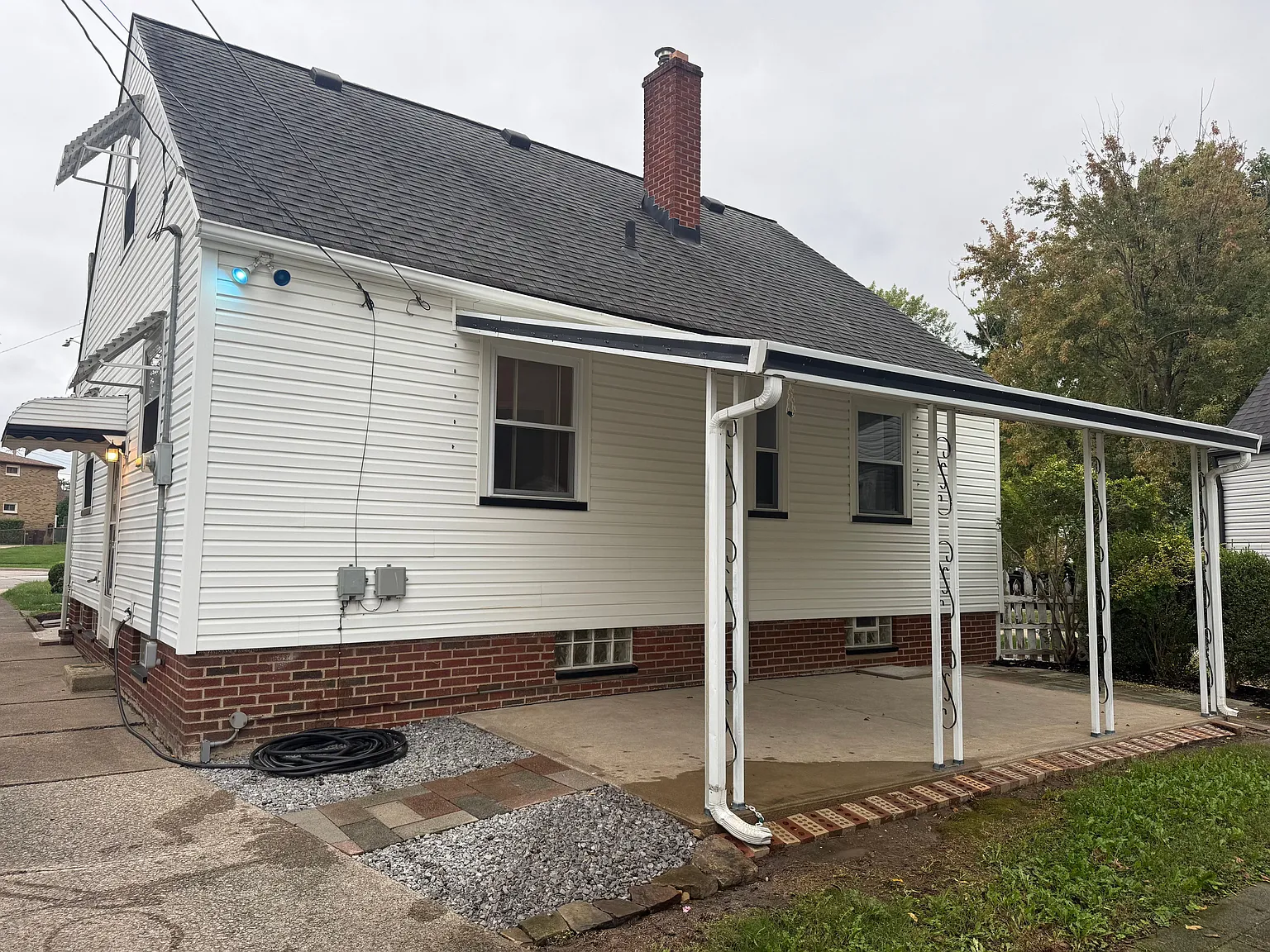 Rear exterior of the home with a large covered concrete patio